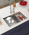 Undermount 14X19 Inch Bar Sink In 16 Gauge Stainless Steel, with dishes and fruit, installed in a white countertop kitchen.