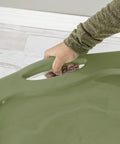 Person holding the grip handle of a Heavy Duty 2 Pack 40 Quart Clear Plastic Storage Bin, showing ease of use.