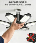 Person installing Garage Light Bulb 150W LED With 6 Adjustable Panels E26 E27 Socket Ultra Bright 15000 Lumens Ceiling Shop Light