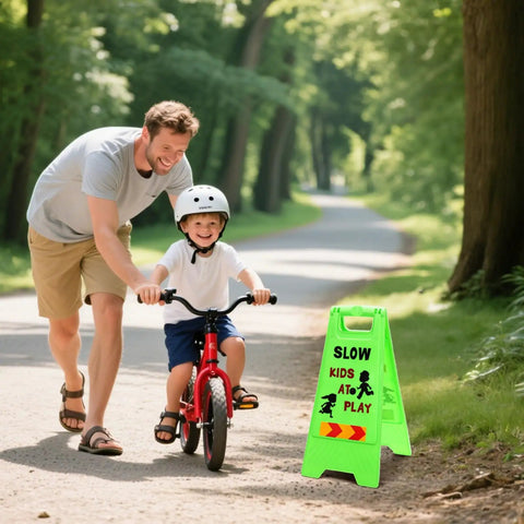 Bright green Three Pack Kids Playing Signs For Street Reflective Slow Down Alert Sign on sidewalk near child riding bike