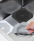 A Total Game Changer 3 Pack Silicone Drain Catchers For Sink And Tub Reusable Hair Strainers in three colors shown in sink.