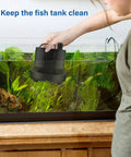Simple Deluxe 800GPH bottom-suction submersible pump, black, held over a glass fish tank with plants.