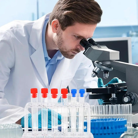 Scientist using microscope next to clear plastic test tube rack for lab and classroom use holds multiple tubes with color caps.
