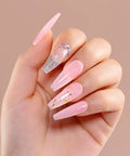 Hand showcasing pink nail extensions using HEMA Free Builder Gel Kit With 6 Colors 15ml Each For Nail Extensions, glitter accents visible