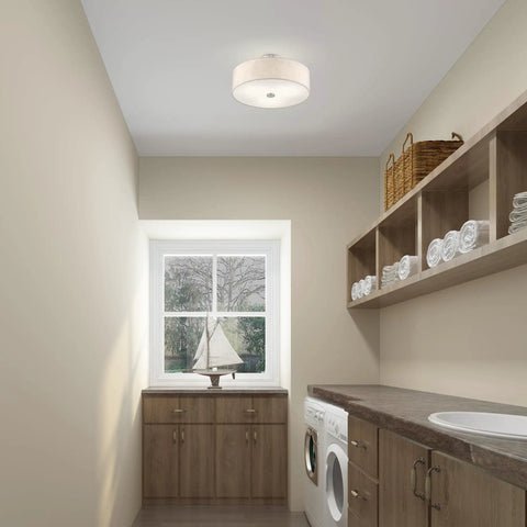Meridian 3 Light Ceiling Mount Fixture In Brushed Nickel With Oatmeal Fabric Drum Shade illuminating a modern laundry room.