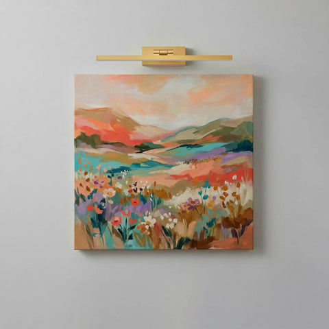 Gold Cordless Picture Lights Set Of Two Rechargeable Wall Mount Art Lamp illuminating a colorful landscape painting on a wall.