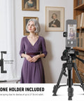 Woman recording video with Beginner Friendly Mini Desk Tripod For iPhone DSLR Camcorder And Webcam, phone holder visible