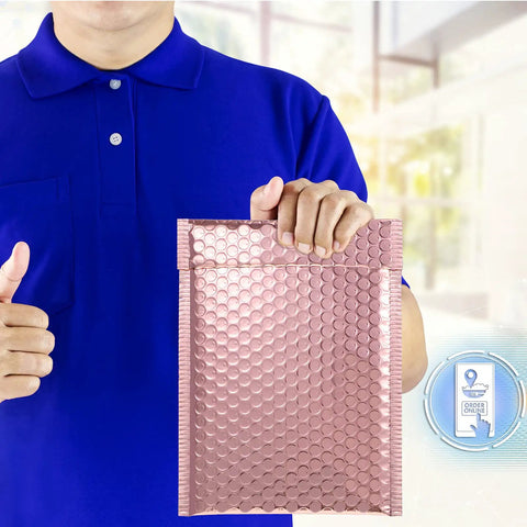 Person holding a rose gold metallic bubble mailer with self seal adhesive, part of a 50 pack padded poly mailers for Valentine shipping.