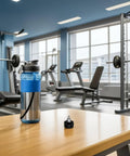 Upgrade Your Ride With These Killer Pull Pin Spring Knobs For Exercise Bikes And Cycling Machines Featuring A Solid 18mm Thread Design Made From Durable Abs Plastic And Iron To Keep Your Indoor Fitness Gear Locked In Tight And Ready For Intense Workouts next to a blue water bottle on a wooden table in a gym.
