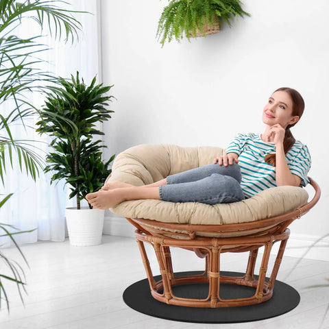 Woman relaxing on recliner using Two Pack 27.25 Inch Round Non Skid Rubber Furniture Pads For Recliners And Swivel Chairs.