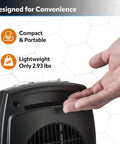 Hand demonstrating size of Compact Ceramic Space Heater CD09250 with adjustable thermostat, ideal for tabletop or under desk use.