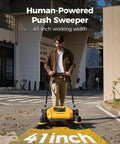 Kick Serious Dust With This Heavy Duty Manual Floor Sweeper Designed For Warehouses And Shops Featuring A 41 Inch Wide Commercial Push Broom That Runs Whisper Quiet And Cuts Through Grit Fast, shown in use outdoors.