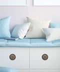 Vintage Round Cabinet Knobs Set Of 10 With Antique Copper Finish on white drawers below blue and white cushions