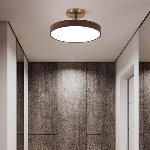 Japanese Style Led Close To Ceiling Light Fixture With Imitation Wood Grain Texture And Sleek Metal Ring illuminated in modern hallway.