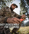 Man demonstrating Take-A-Part Poultry And Small Game Shears With Serrated Blades, Pivot Pin Release, Bright Orange Rubber Handle, 5.5 Inch.