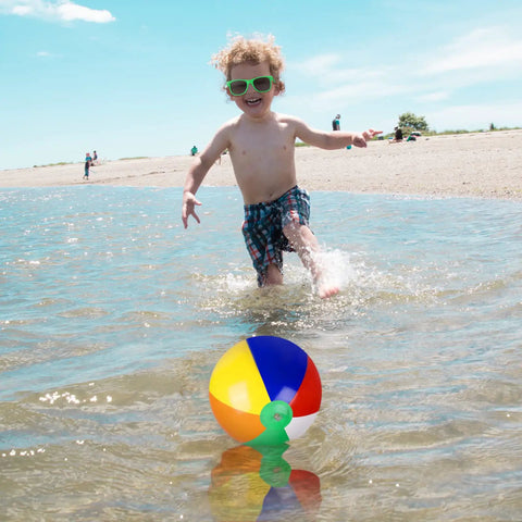 Child playing on a beach with a colorful beach ball from Inflatable Beach Balls And Neon Sunglasses Set For Pool Party Favors 48 Pack Includes 24 Beach Balls And 24 Sunglasses Adults Summer Water Fun Toys Beach Park Backyard Party Supplies.