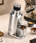 Elite Coffee Grinder With Eighty Millimeter Stainless Steel Flat Burrs For Smooth Espresso Pulls And Fresh Crush Reliability Variable Speed Motor Ultra Calibrated Stepless Control And A Solid Seventy Gram Hopper For Daily Coffee Sessions, featuring a sleek silver design and freshly ground coffee.