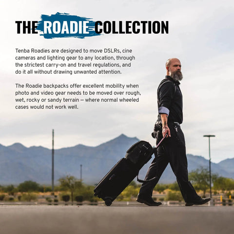 Man walking with carry-on camera backpack for DSLR and mirrorless gear, suitable for rough terrains, mountains in background.