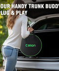 Woman holding a black Calion trunk organizer bag while leaning into a car trunk, showcasing its convenient plug and play feature.