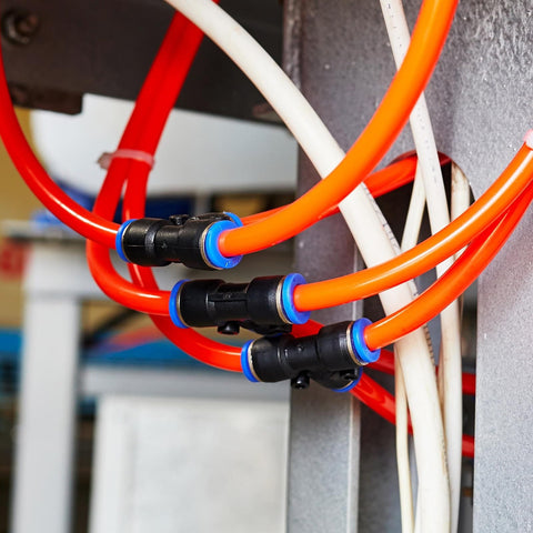 Inline 5 Way Manifold Union Fitting Kit, 6mm OD Plastic Pneumatic Push To Connect Tube Fittings in use with orange tubing.