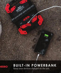 Omni 2K Rechargeable Work Light With 2000 Lumens Six Light Modes Rotating Magnetic Handles charging a phone on job site