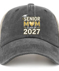 Gray trucker cap with 'Senior Mom Class of 2027' text, adjustable buckle, and curved brim for all-season wear.