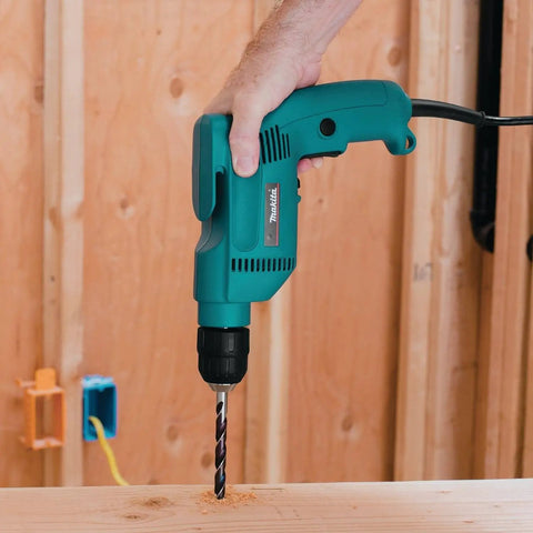 Powerful 4.9 Amp 3/8 Inch Drill With Variable Speed 0-2500 RPM Keyless Chuck Large Trigger Teal Finish in action on wood