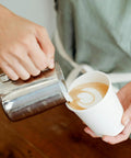 Pouring latte art into 200 Pack 16 Oz Disposable Coffee Cups Sturdy White Paper Cups For Hot And Cold Drinks Leak Proof Coffee Cups