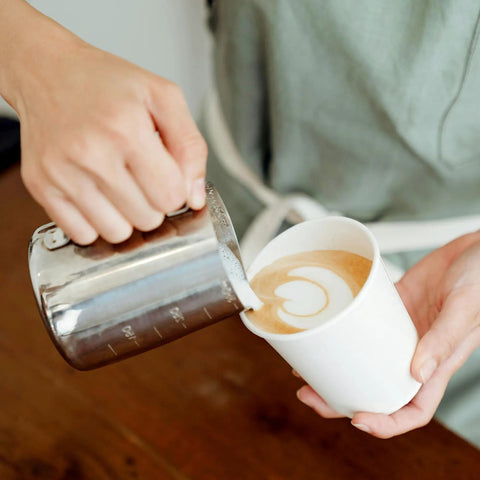 Pouring latte art into 200 Pack 16 Oz Disposable Coffee Cups Sturdy White Paper Cups For Hot And Cold Drinks Leak Proof Coffee Cups