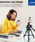 Woman using Beginner Friendly Mini Desk Tripod For iPhone DSLR Camcorder at desk with laptop and coffee cup.
