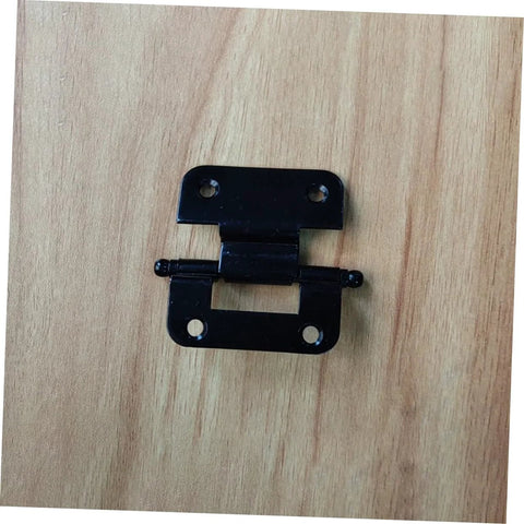 Front view of black metal cabinet hinge with mounting plates on wood surface