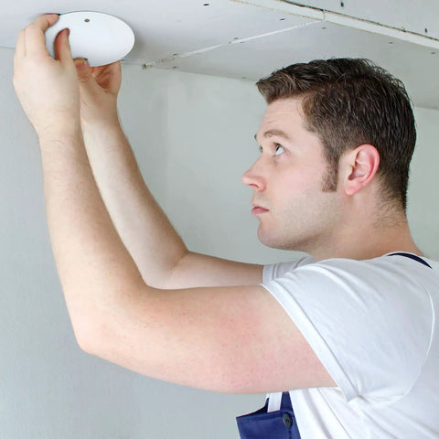 Man installing Six Pack White Round Ceiling Cover Plates With M3.5 Screws 5 Inch Blank Junction Box Covers For Fans And Ceiling Lights