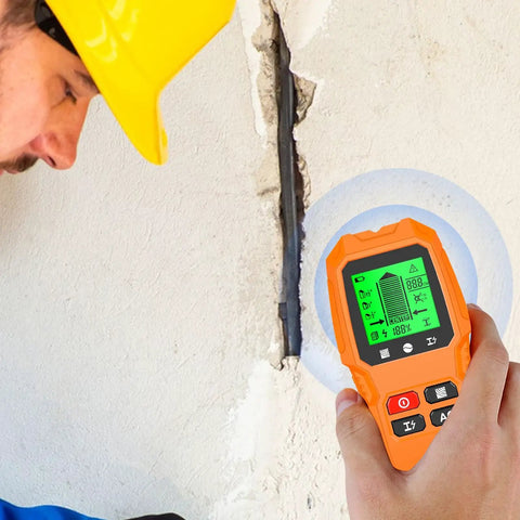 Man using Wall Stud Finder Scanner LCD Display Electric Portable on wall crack, showing detection mode on screen.