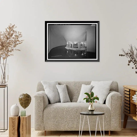 Vintage Framed Print Of Wilson Dam And Hydroelectric Plant Turbine And Generator Spanning The Tennessee River At Wilson Dam Road In Muscle Shoals AL Wall Art For History Buffs Reproduction From Library Of Congress Archive displayed above a sofa in a living room.