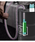 Compact Compatible With Makita 18-Volt Rechargeable Battery Powered 2 In 1 Electric Transfer Pump For Diesel Oil And Water Super Handy For Jobsites And Car Maintenance connected to oil drum with hose.