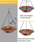 Outdoor Hanging Bird Bath In Antique Copper Metal With 17 Inch Rust Proof Black Chains Durable Iron Bird Feeder Bowl For Garden And Backyard Decor Weather Resistant And Easy To Clean, shown with fountain and rocks.