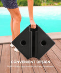 Heavy Duty 4 Piece Patio Umbrella Base Weights 220 Lbs Fillable With Water Or Sand Square Base being carried by person on deck