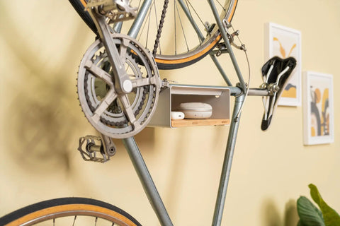 Wall Mounted Bike Rack With Bamboo Shelf For Indoor Storage And Decor holding a bicycle and decor against a beige wall
