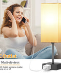 Woman smiling while using phone near Set Of 2 Minimalist Table Lamps With AC Outlets For Bedroom, Cozy Night Light Vibe, Bulbs Included.