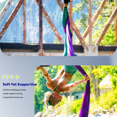 Person performing aerial dance using purple silk rigging against outdoor industrial backdrop