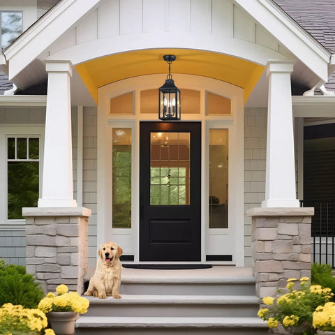 Badass Matte Black Outdoor Pendant Lighting Three Bulb Exterior Hanging Porch Fixture With Clear Glass Shades All Weather Housing For A Seamless Front Step Glow Up above a front door with yellow accents and a dog.