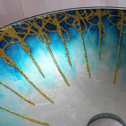 Close-up of USZWBY Gradient Color Artistic Vessel Sink Bowl-Shaped Tempered Glass with golden details, modern bathroom design.