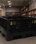 Kickass Workhorse Industrial Grade Collapsible Bulk Box With 1700 Pound Capacity And Four Way Forklift Access For Warehouse Material Handling And Retail Storage Made In Usa in black, stored indoors.