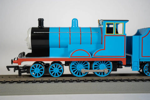 Side view of Edward Engine From Thomas And Friends HO Scale Train With Moving Eyes And Realistic Body All Metal Wheels And Smooth Hook And Loop Couplers Great On 18 Inch Radius Curves Kid Friendly Collector Favorite Model on track