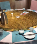 Rides Smooth Across Any Dining Surface This Rechargeable Electric Lazy Susan Turntable on a gold table setting.