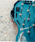 Close-up of 20-Piece Lawn Aerator Shoes With Metal Spikes on a blue sole, highlighting durable spikes for better soil health.