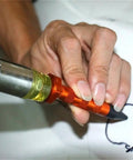 DIY Paintless Dent Repair Kit With 9 Heads Tap Down Pen For Small Dings And Hail Damage being used on flat metal surface.