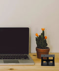 Heavy Duty Under Desk Laptop Mount With Scuff Proof Rubber Pads, Smooth Glide Keyboard Shelf And Compact Workstation Organizer That Truly Levels Up Your Home Office Setup next to a laptop and a cactus.