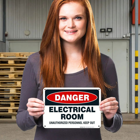 Hella Tough Aluminum Electrical Room Sign For Indoor And Outdoor Areas Killer Rust Proof Coating held by a woman in a warehouse.