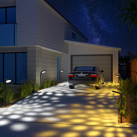 Four Pack Solar Pathway Lights For Outdoor Use No Wiring Required Waterproof Landscape Lighting illuminating driveway with patterns